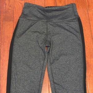 Grey cropped leggings with black side line.